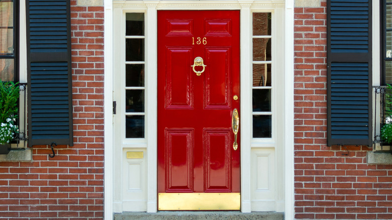 Close-up of a red front door with a high-gloss finish