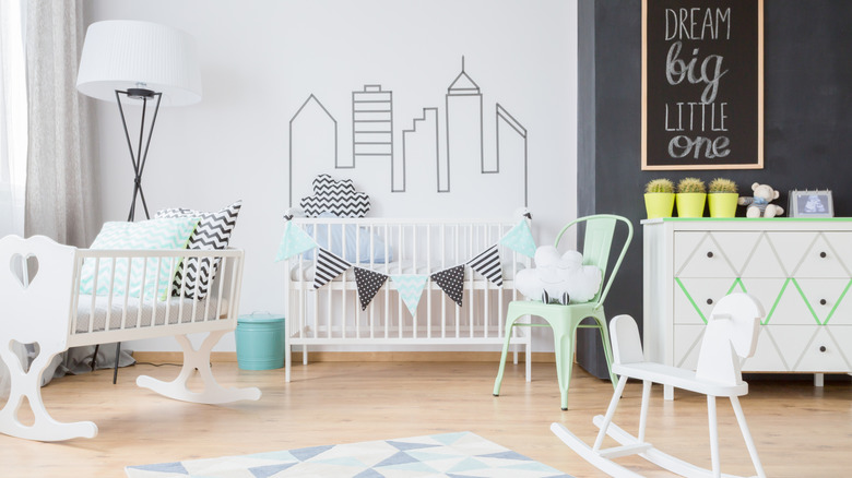 a black and white city-themed nursery with green accents