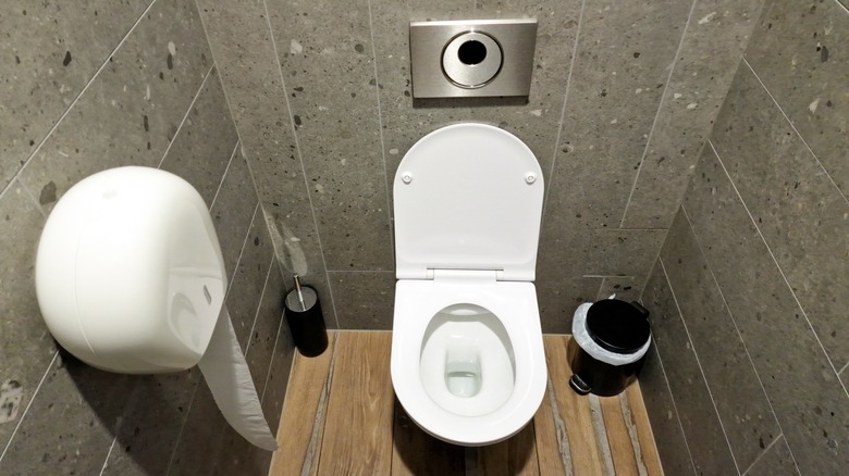 Toilet with sensor in background