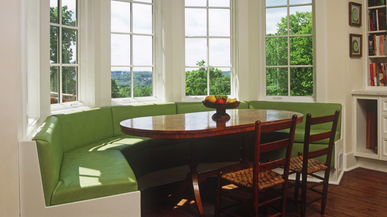 A dining nook with a table and banquette seating