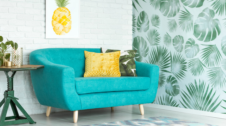 Palm leaf wallpaper and couch