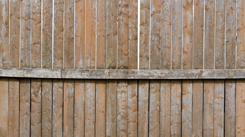 Wooden fence that is weathered and warping