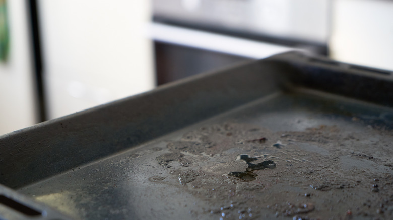 Corner of a dirty black baking sheet