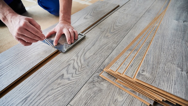 Person installing laminate flooring