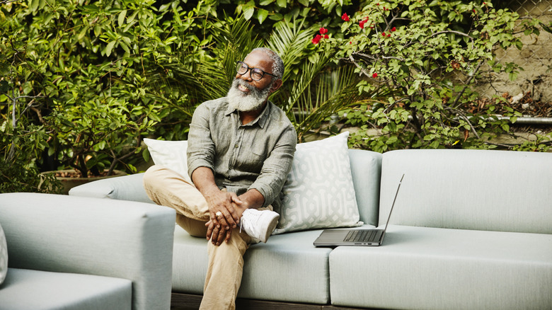 Man sitting on outdoor couch