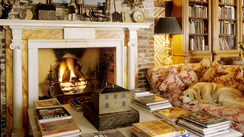 A cottage style room with a coffee table covered in books