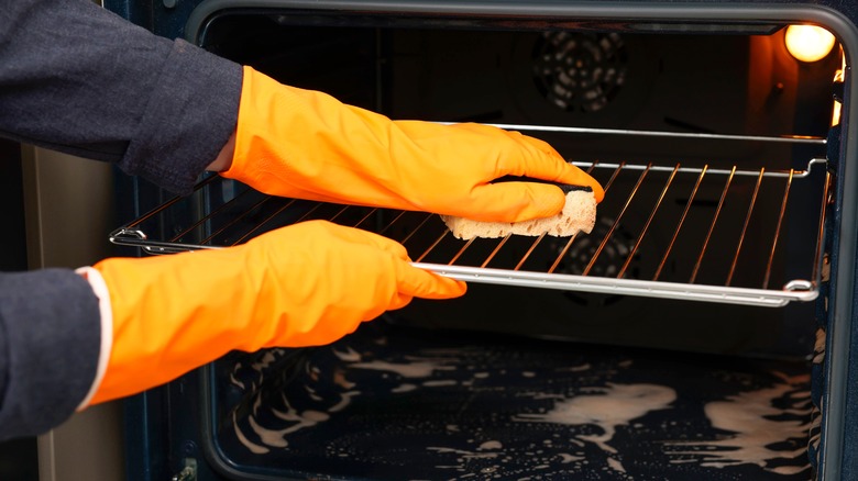 Persons cleaning the oven