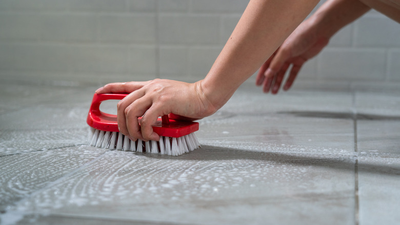 person scrubbing marble floor