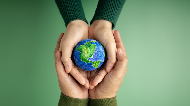 People holding globe in hands