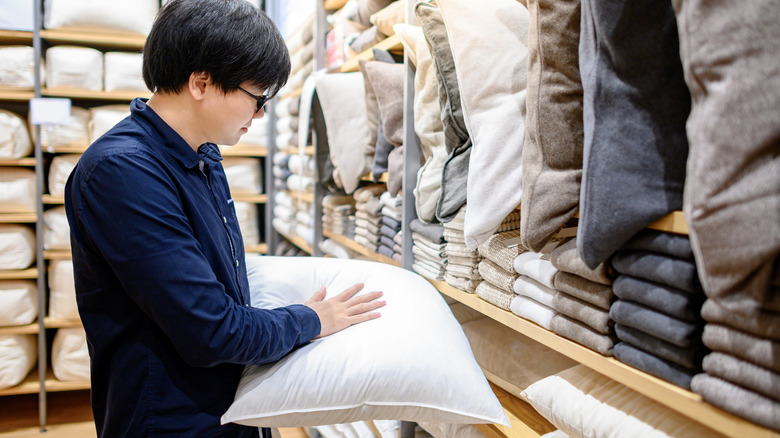 man shopping for throw pillows