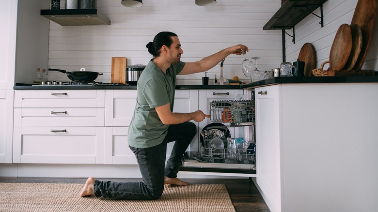 Man loading dishwasher