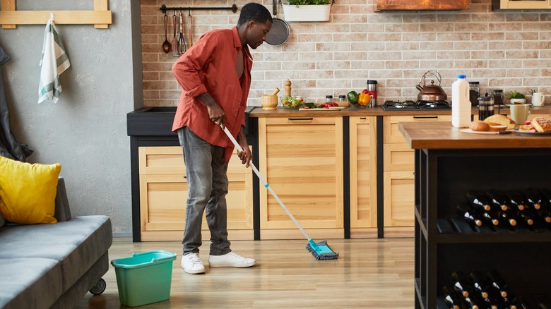 man mopping kitchen floor