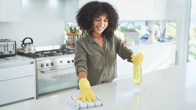 Woman cleans countertops
