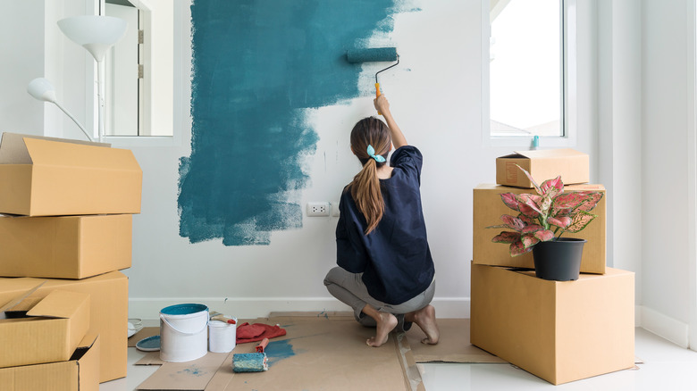 Woman painting a wall