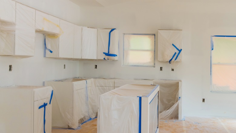 kitchen covered in plastic for painting