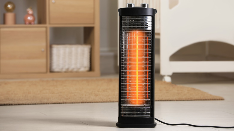 A space heater is in a room with wood furniture