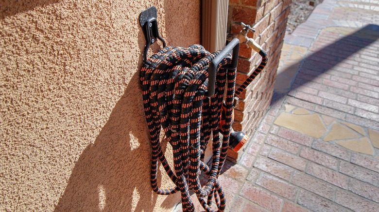 expandable hose hanging on wall