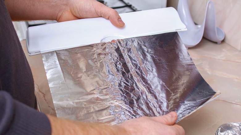 Person holding sheet of foil