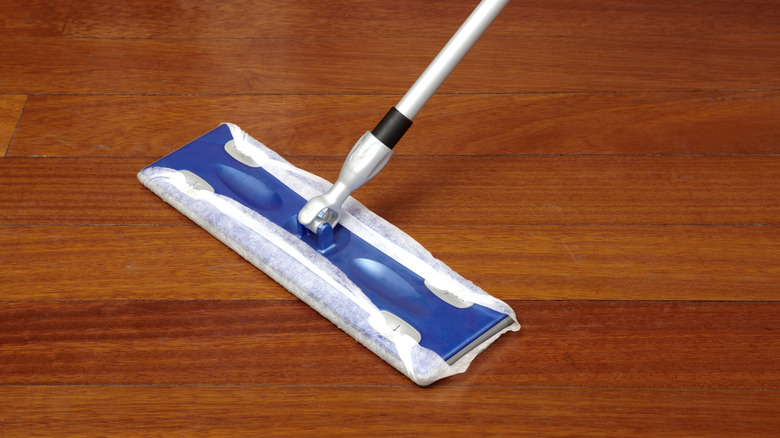 A Swiffer-style mop on hardwood flooring