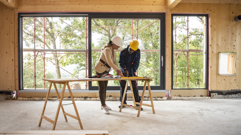 Man and woman looking at sawhorse