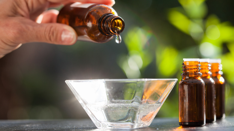 Pouring essential oils outside