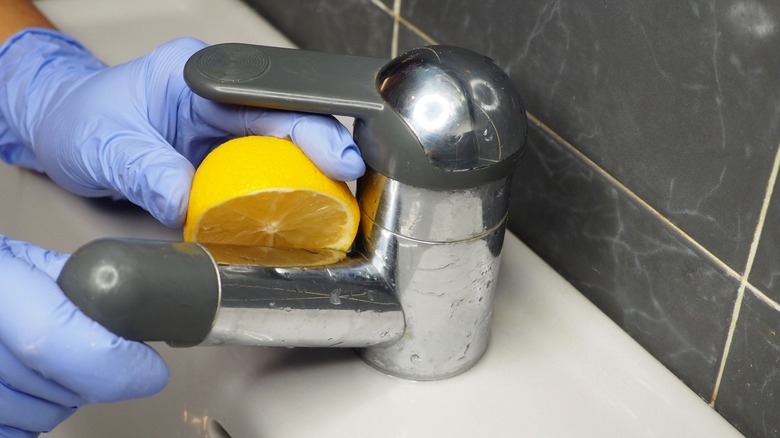 Cleaning faucet with lemon