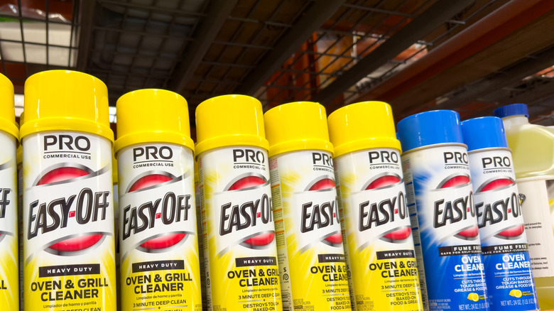 A row of Easy-off chemical oven cleaners are lined up in a shopping aisle