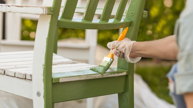 person painting chair