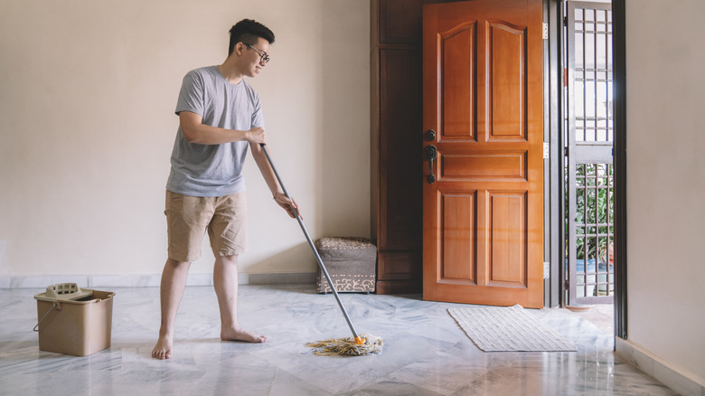 Man mopping a marble floor