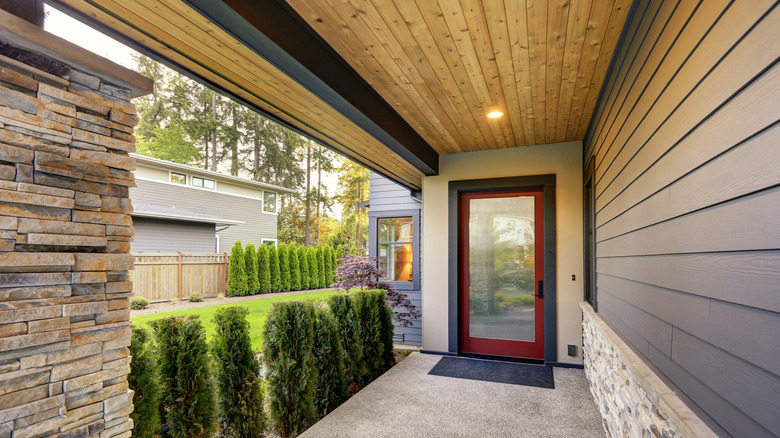 An open porch with a more rustic style ceiling.