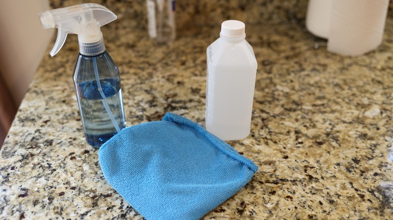 Spray bottle, alcohol, and microfiber cloth