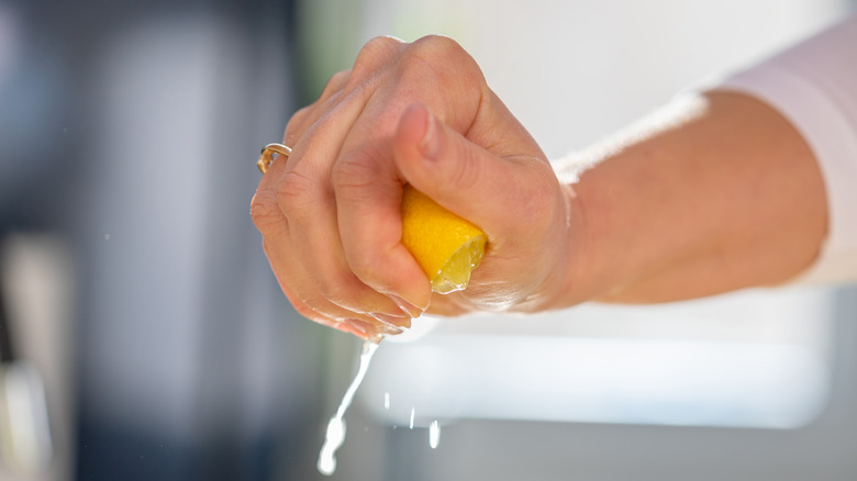 Woman squeezing a lemon