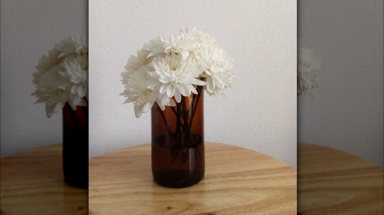 white flowers in amber vase