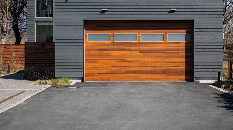 a house garage door and stained driveway