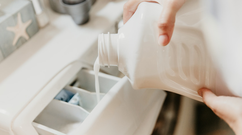 Pouring detergent in machine