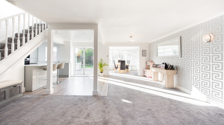 A modern living room with wallpaper using the Greek key pattern