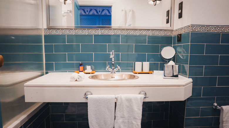 A bathroom with tile trim in the Greek key pattern