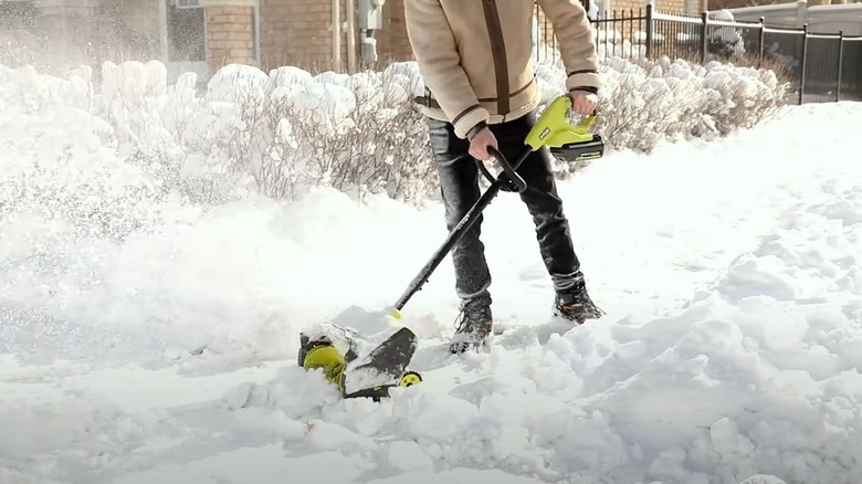 man blowing snow with Ryobi shovel