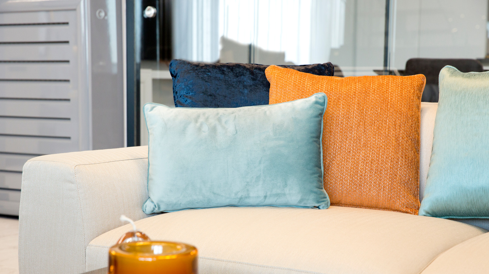 https://www.housedigest.com/img/gallery/is-there-such-a-thing-as-having-too-many-pillows-on-a-couch/l-intro-1656036163.jpg