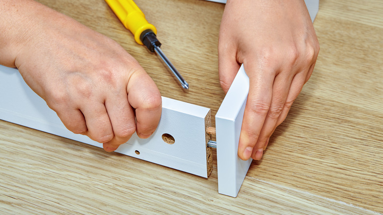 Person fitting two boards together