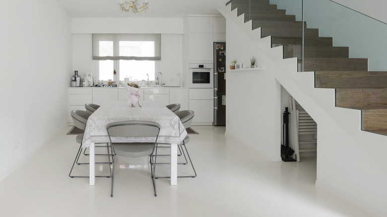 A kitchen and dining room with a white epoxy floor