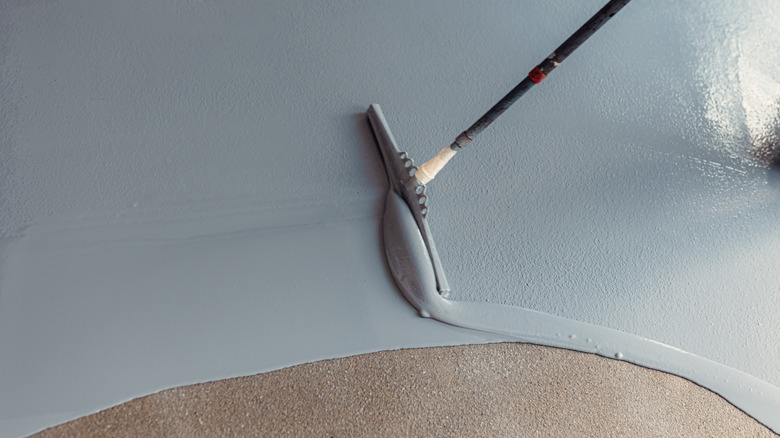 A worker installing epoxy floors