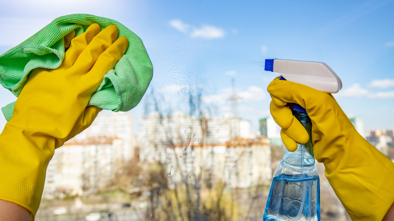 Cleaning windows with spray bottle