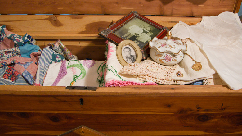 Cedar chest with linens and photos inside