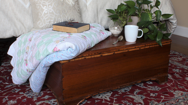 Cedar chest at the foot of a bed