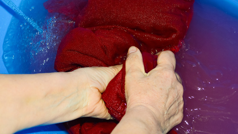 hands soaking sweater in water