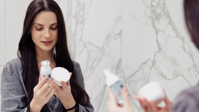 woman with skincare products