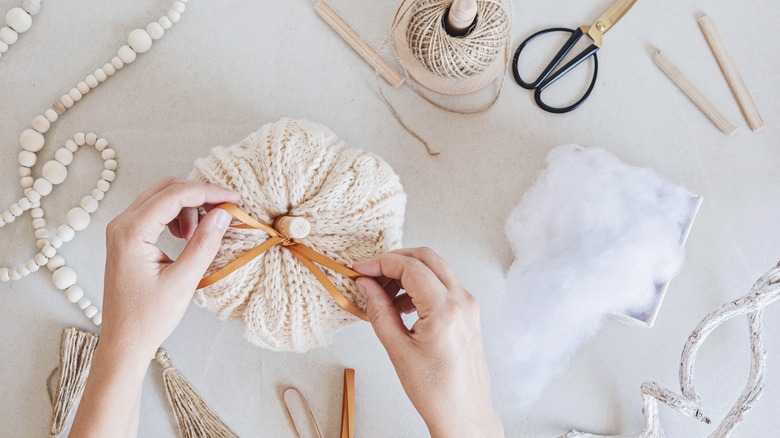 person making DIY pumpkins