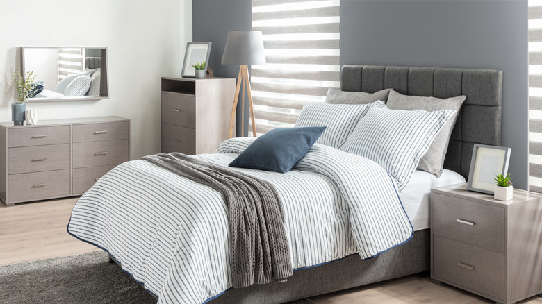 Gray bedroom walls with striped linens