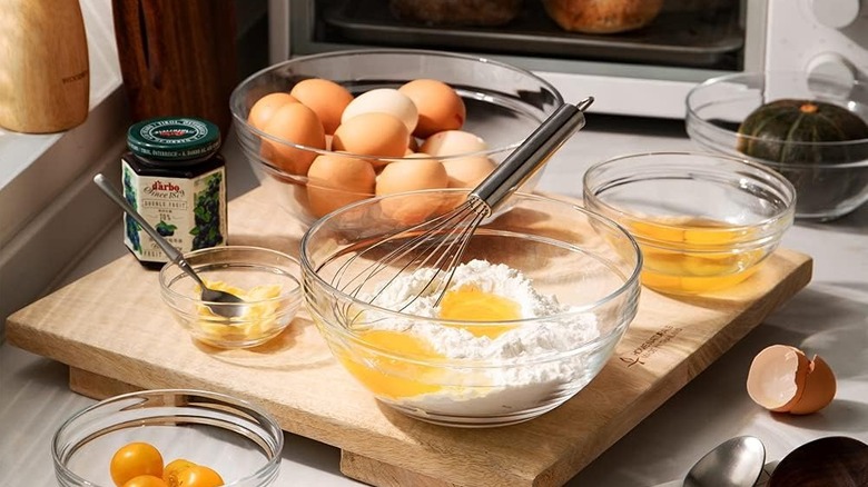 baking ingredients in glass bowls on wood cutting board